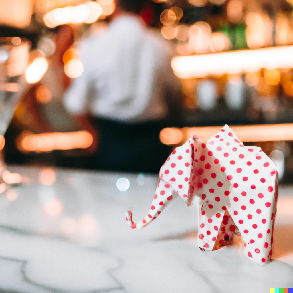 Prompt: Photo of a pink polka-dot origami elephant on a white marble surface at a cocktail bar, with bartender in background bokeh