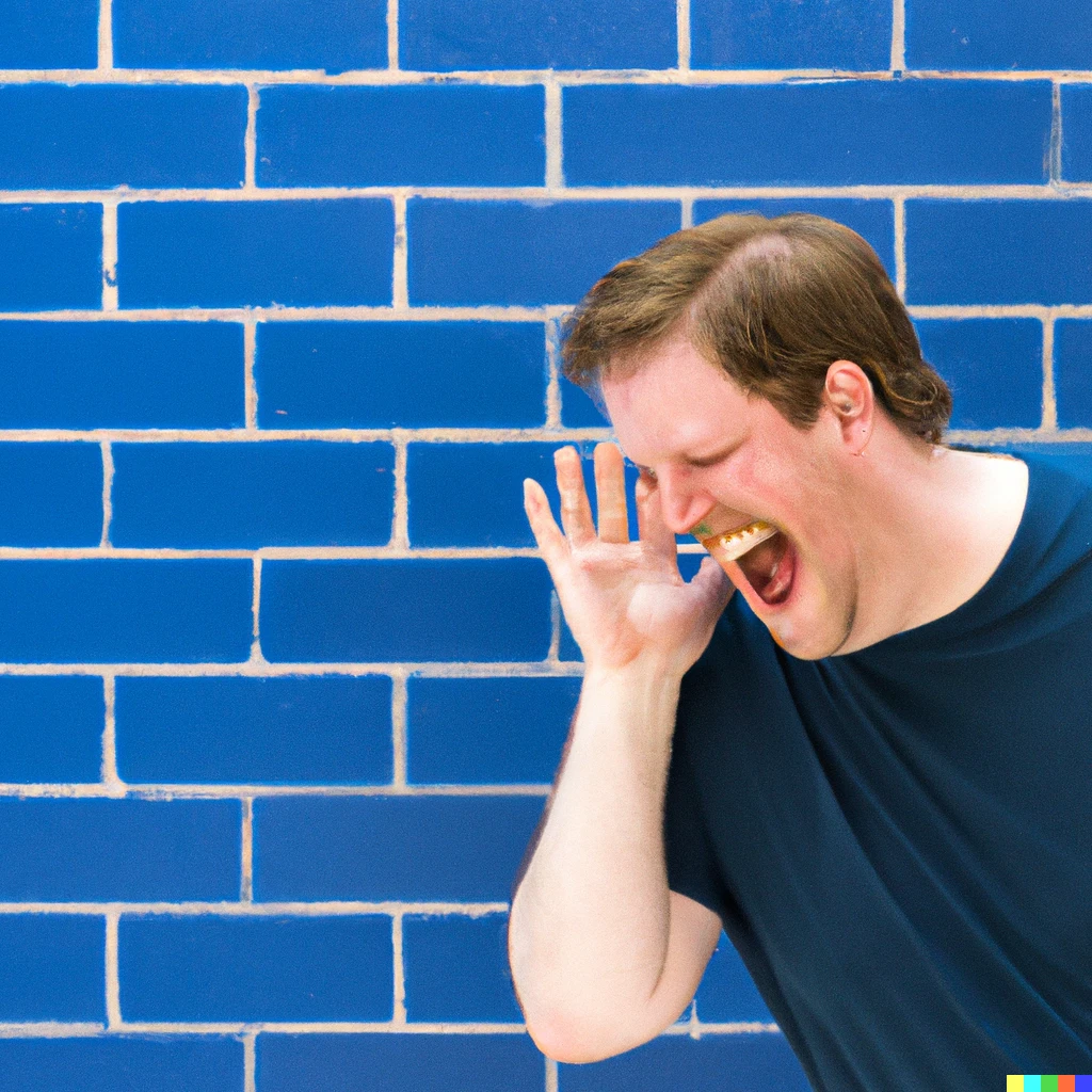 Prompt: Deaf person laughing standing behind bright blue brick wall.